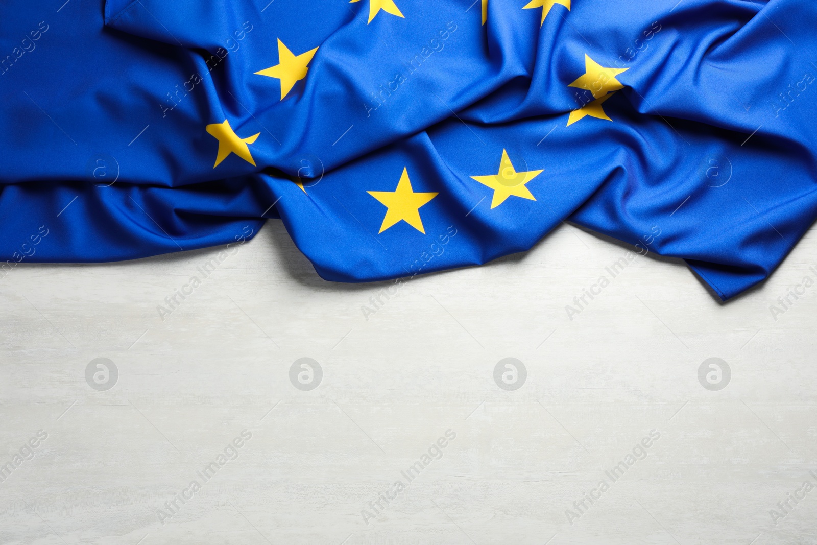 Photo of Flag of European Union on white textured background, above view. Space for text