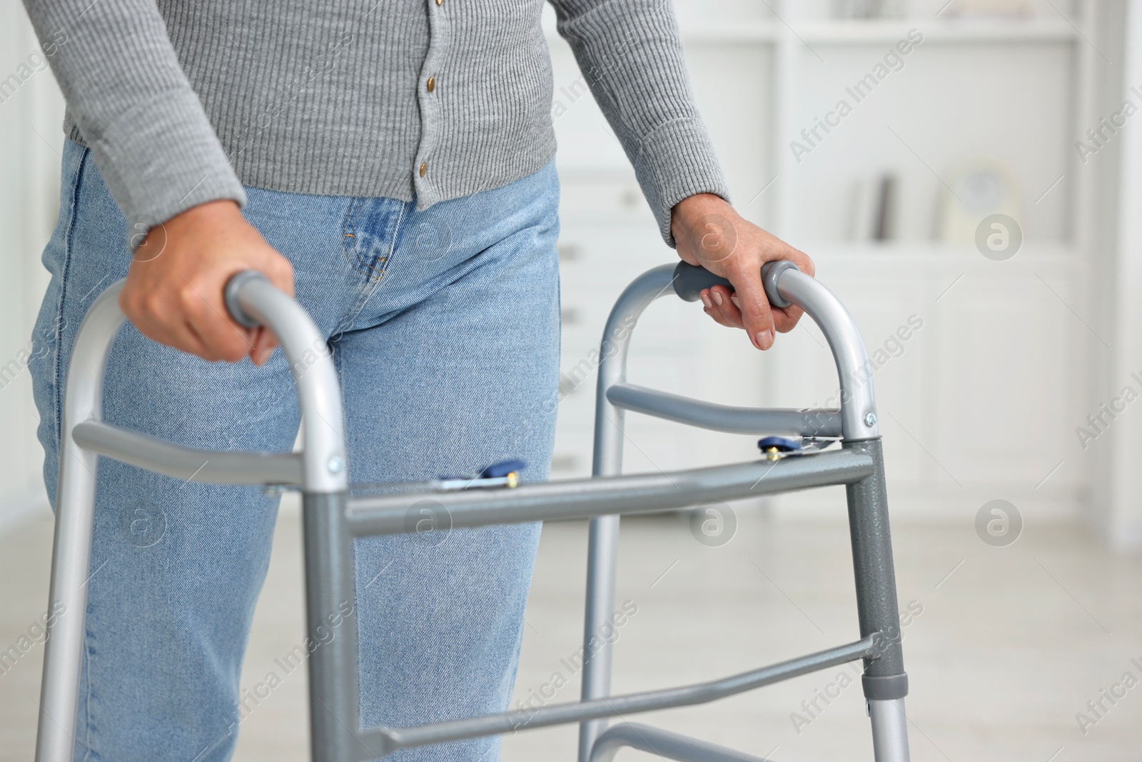 Photo of Senior woman with walking frame at home, closeup