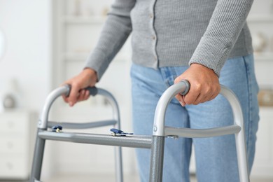 Photo of Senior woman with walking frame at home, closeup