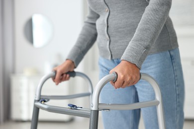 Photo of Senior woman with walking frame at home, closeup