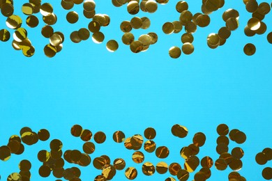 Photo of Shiny confetti on light blue background, top view. Space for text