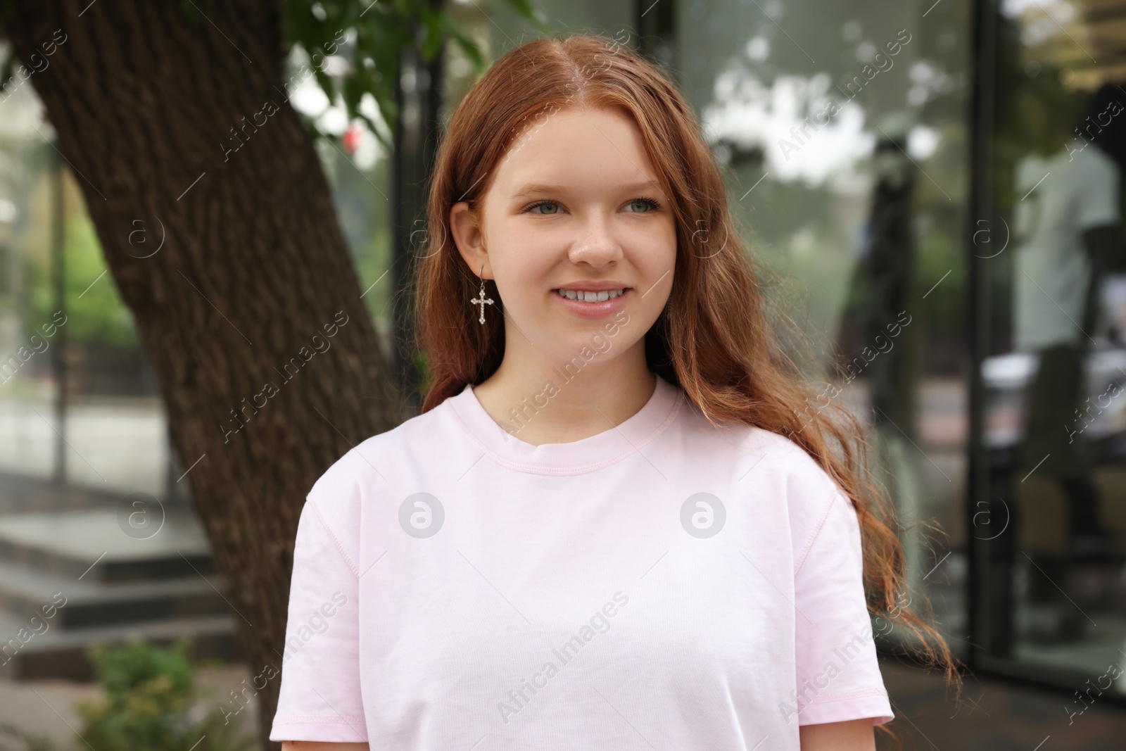 Photo of Portrait of beautiful teenage girl on city street