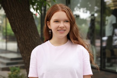 Photo of Portrait of beautiful teenage girl on city street