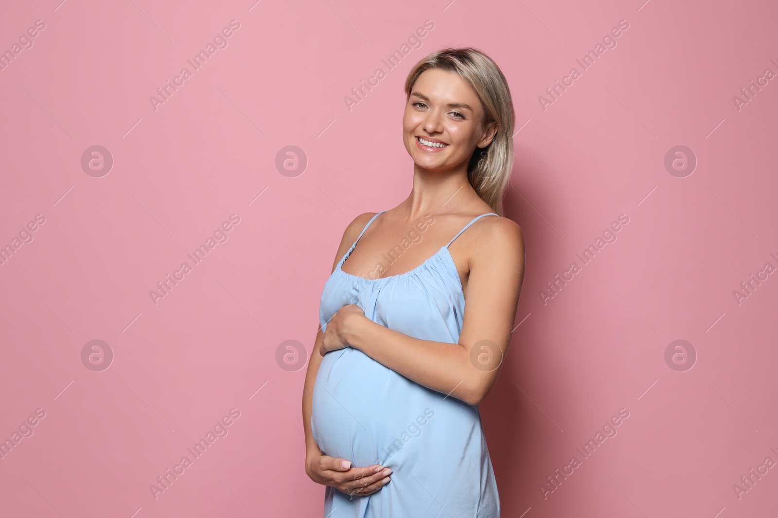 Photo of Portrait of beautiful pregnant woman on pink background