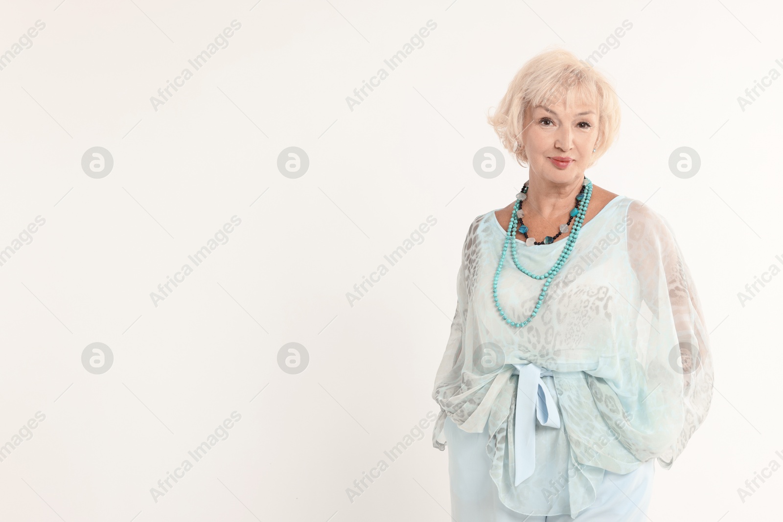 Photo of Portrait of beautiful senior woman on white background, space for text