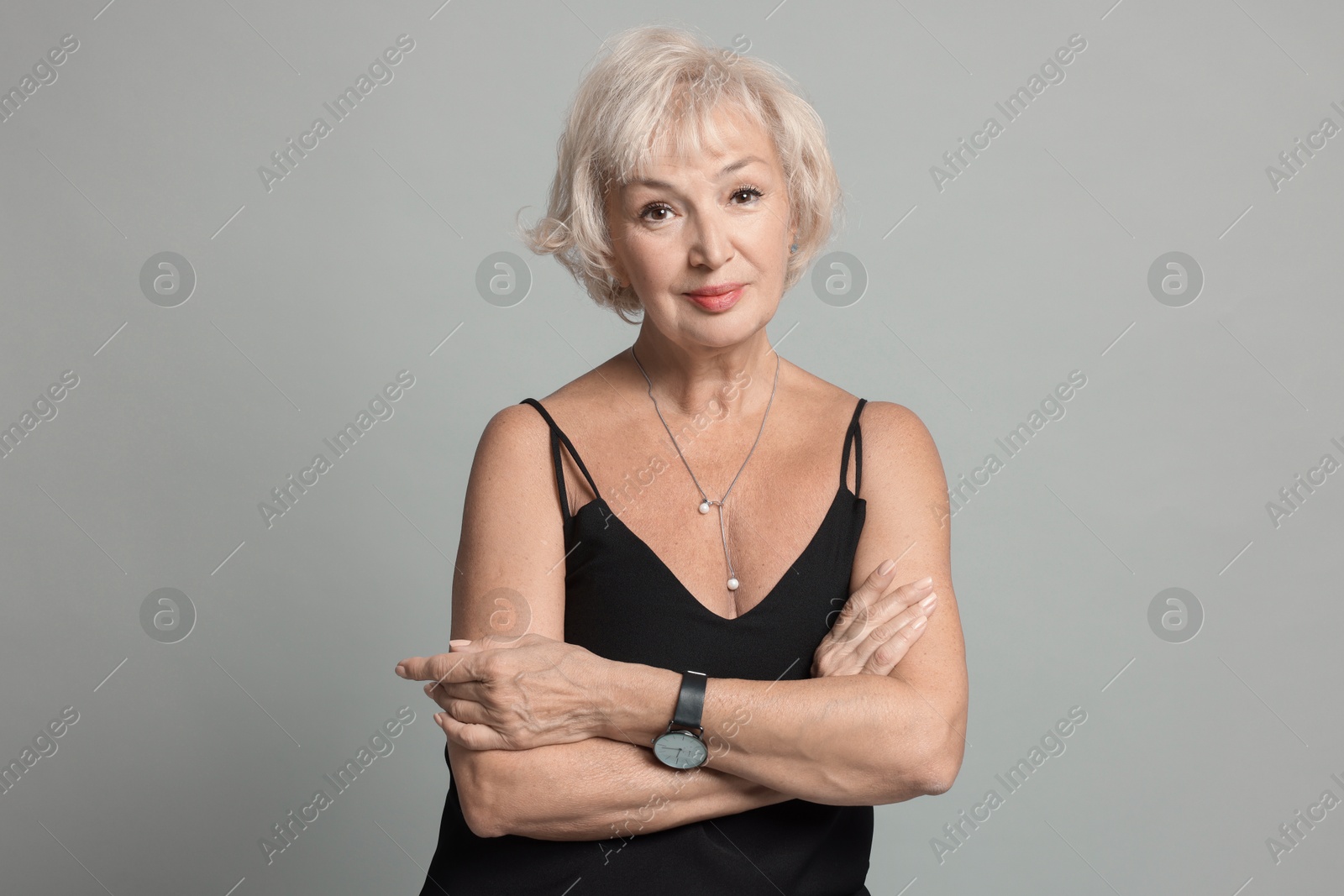 Photo of Portrait of beautiful senior woman on light grey background