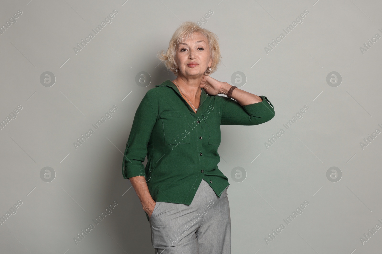 Photo of Portrait of beautiful senior woman on light grey background