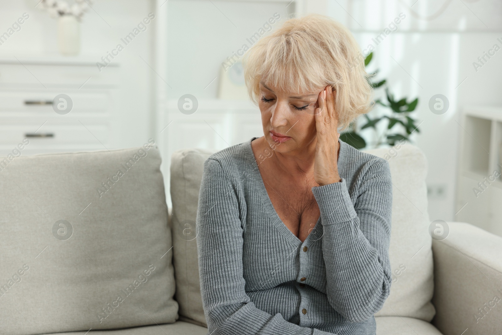 Photo of Beautiful senior woman suffering from headache at home