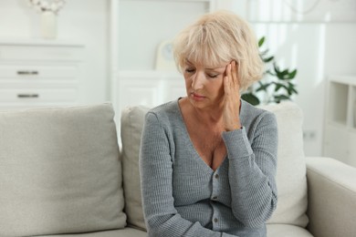 Photo of Beautiful senior woman suffering from headache at home