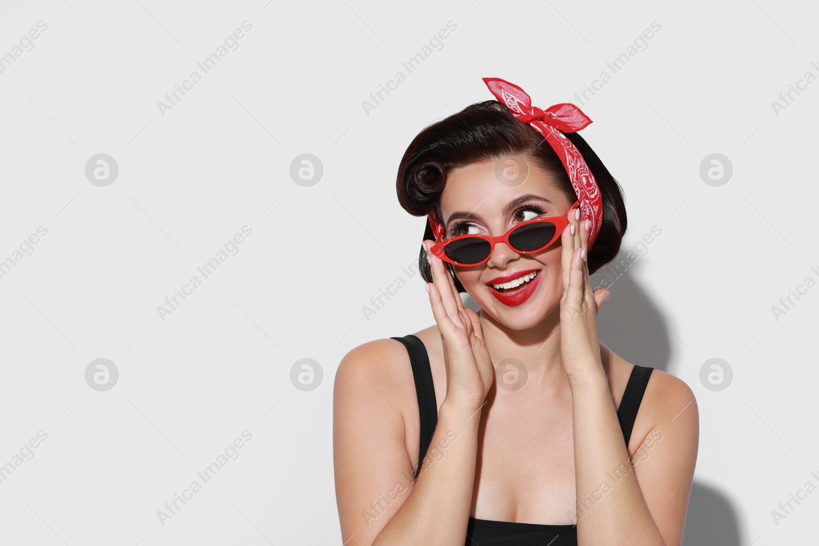 Photo of Portrait of pin-up woman on light background, space for text