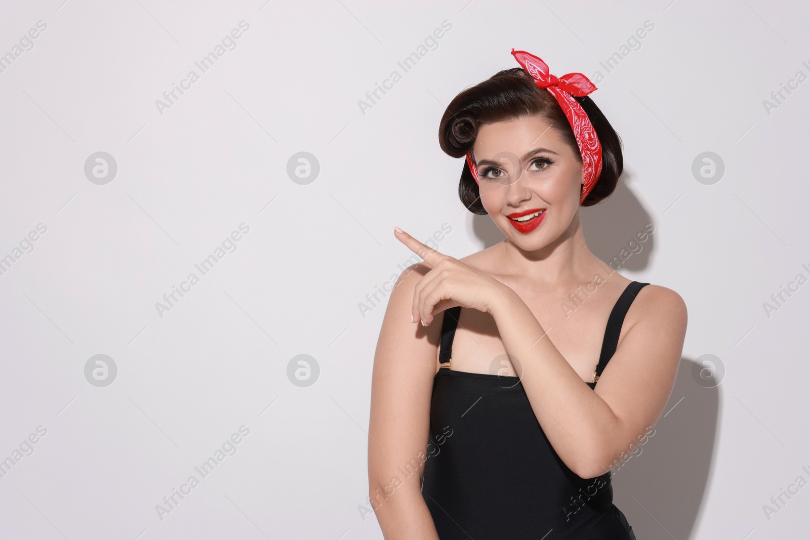 Photo of Portrait of pin-up woman on light background, space for text