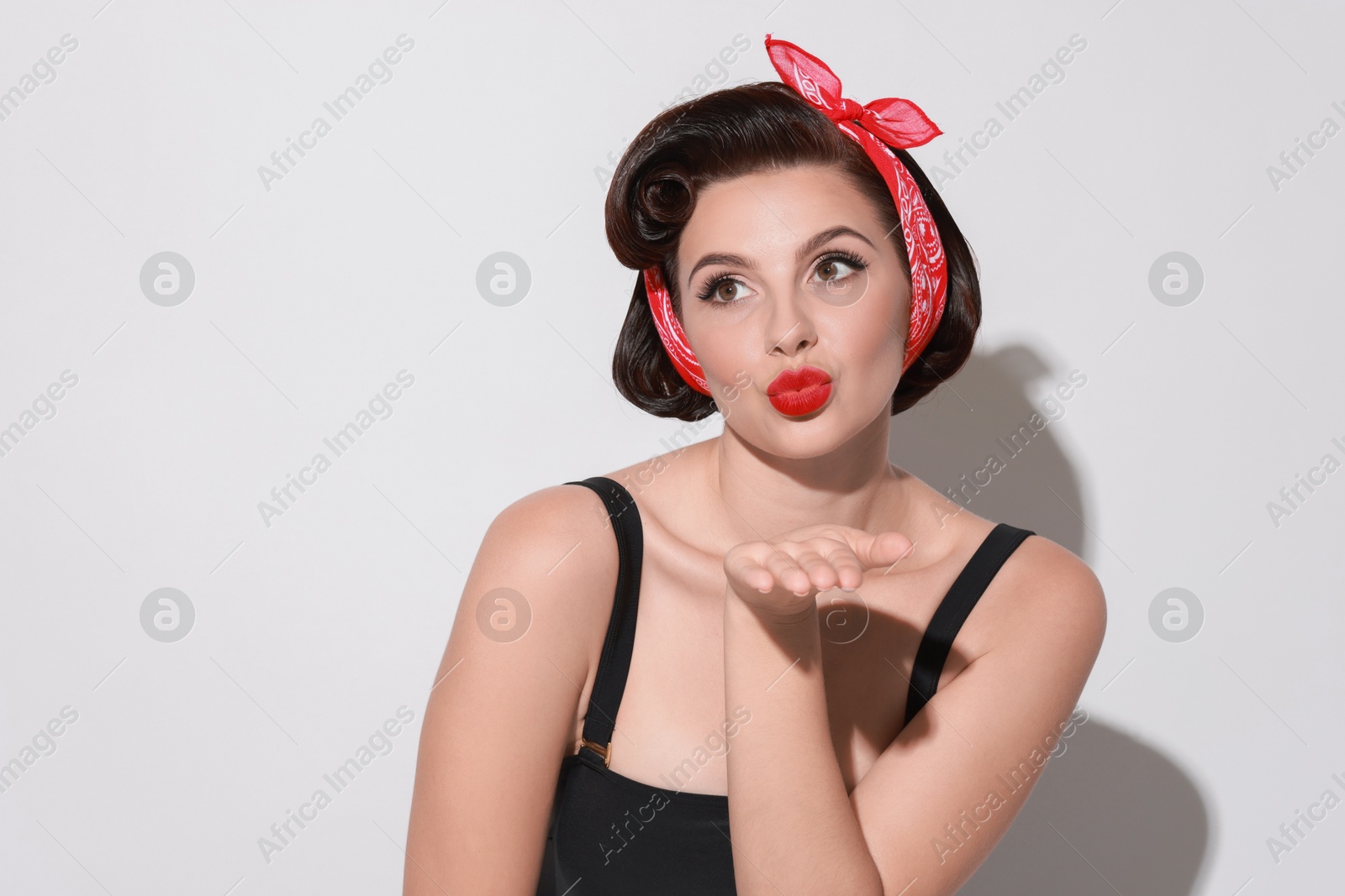 Photo of Portrait of pin-up woman on light background