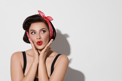 Photo of Portrait of pin-up woman on light background