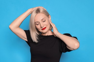 Photo of Woman with perfect makeup on light blue background