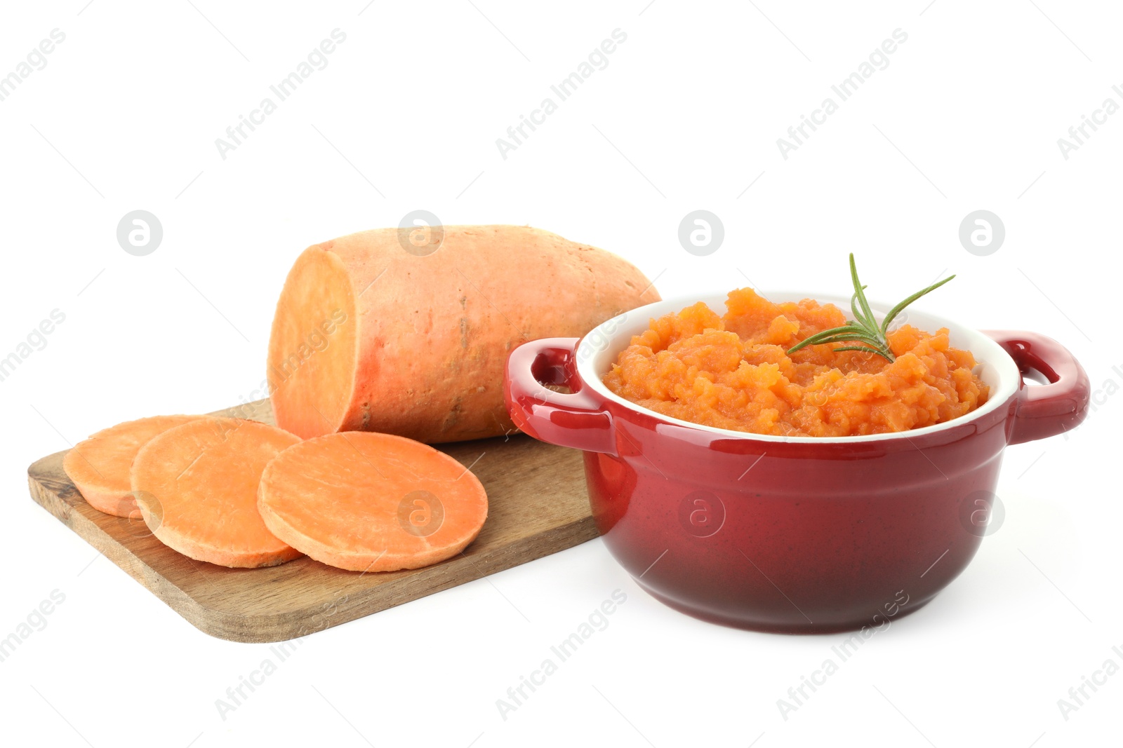 Photo of Tasty mashed sweet potato with rosemary in pot and cut vegetable isolated on white