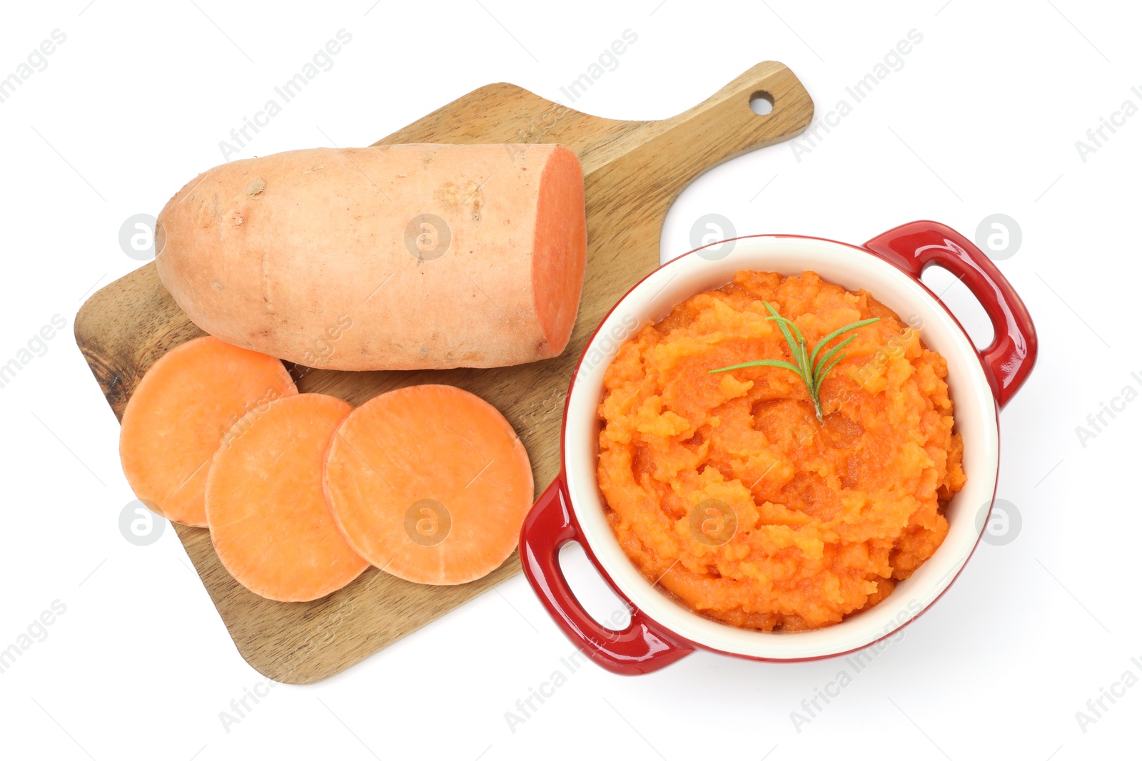 Photo of Tasty mashed sweet potato with rosemary in pot and cut vegetable isolated on white, top view