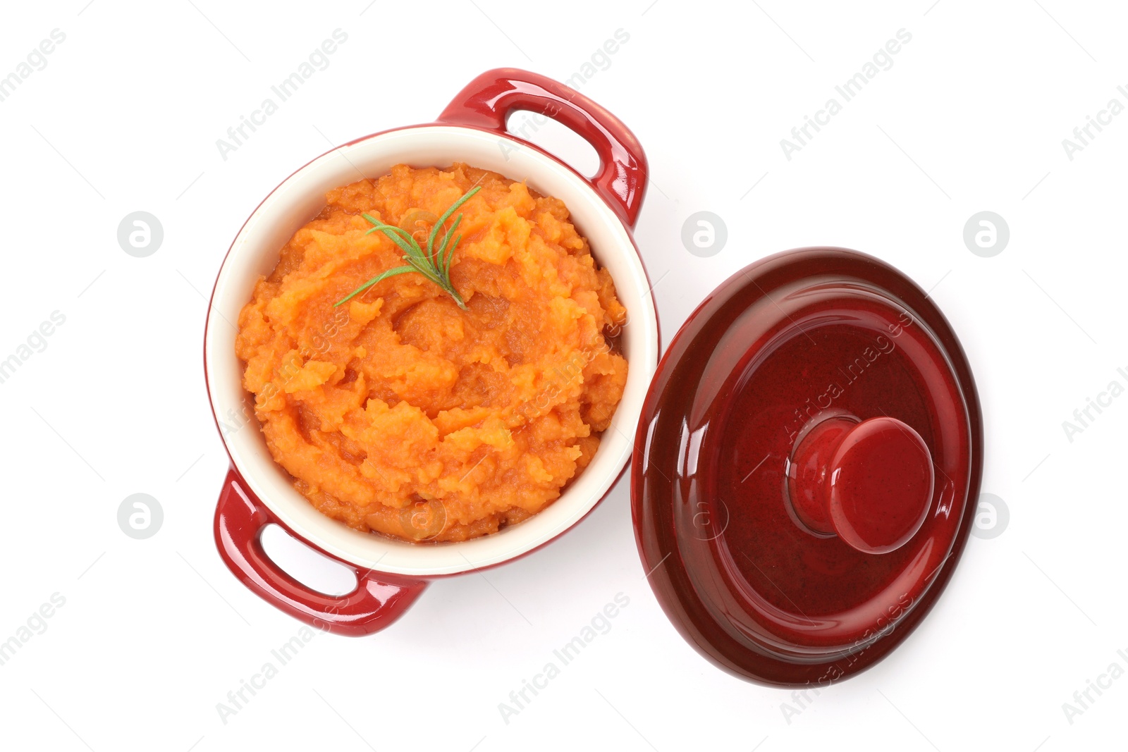 Photo of Tasty mashed sweet potato with rosemary in pot isolated on white, top view