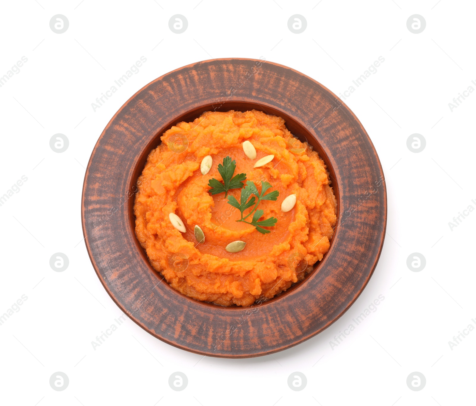 Photo of Tasty mashed sweet potato with pumpkin seeds and parsley in bowl isolated on white, top view