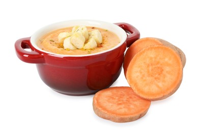 Photo of Delicious sweet potato soup with croutons and fresh vegetable isolated on white