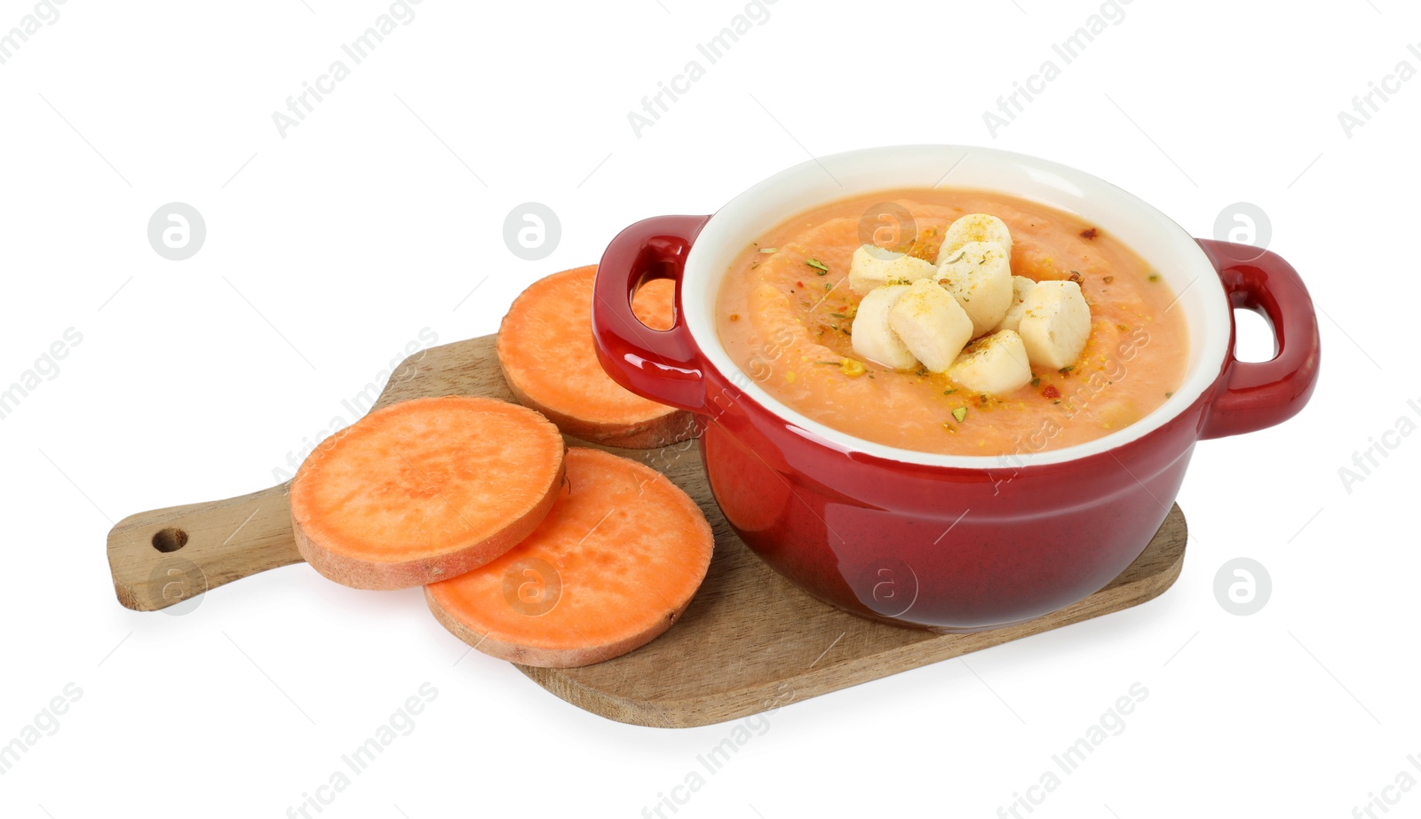 Delicious sweet potato soup with croutons and fresh vegetable isolated on white Photo of Delicious sweet potato soup with croutons and fresh vegetable isolated on white