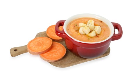 Photo of Delicious sweet potato soup with croutons and fresh vegetable isolated on white