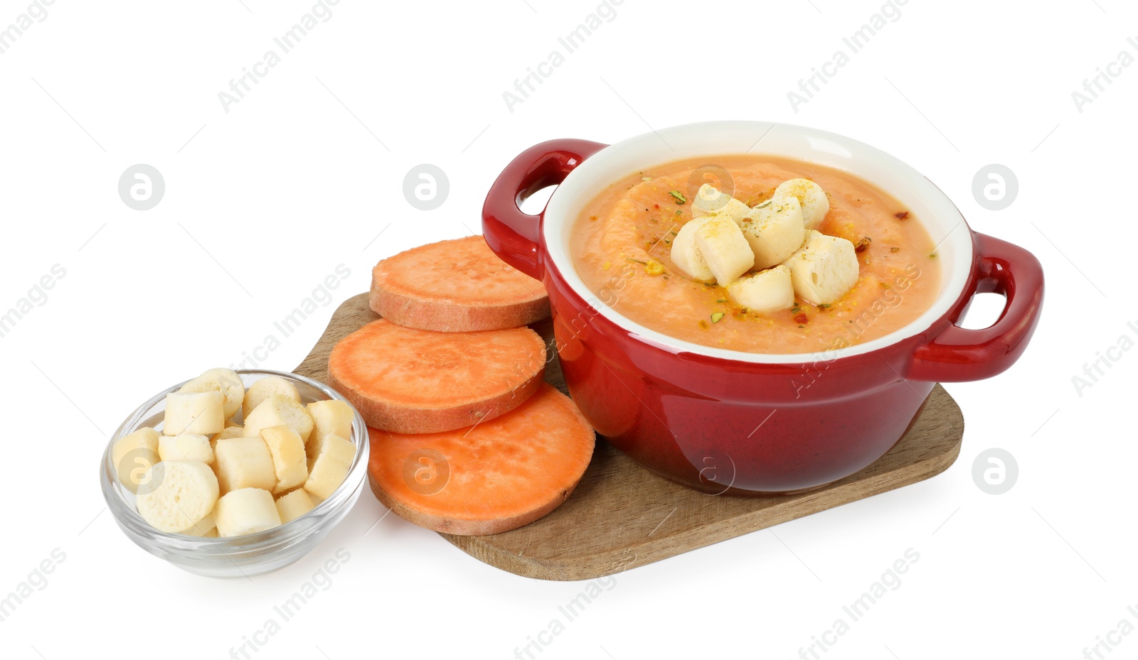 Photo of Delicious sweet potato soup with croutons and fresh vegetable isolated on white