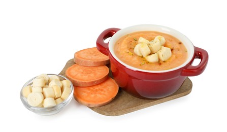 Photo of Delicious sweet potato soup with croutons and fresh vegetable isolated on white