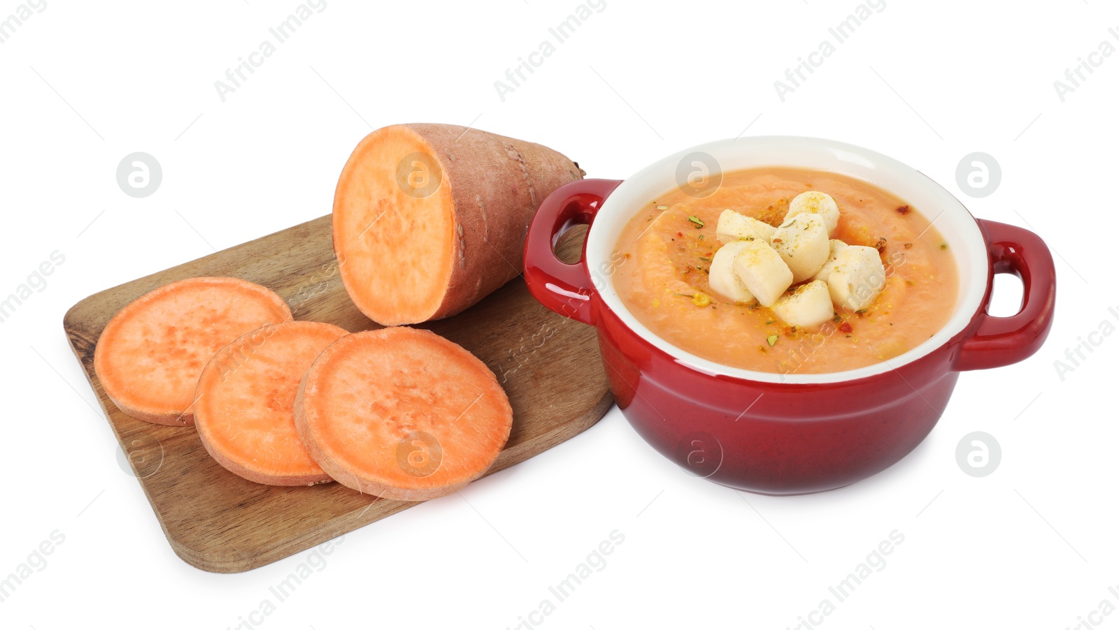 Photo of Delicious sweet potato soup with croutons and fresh vegetable isolated on white