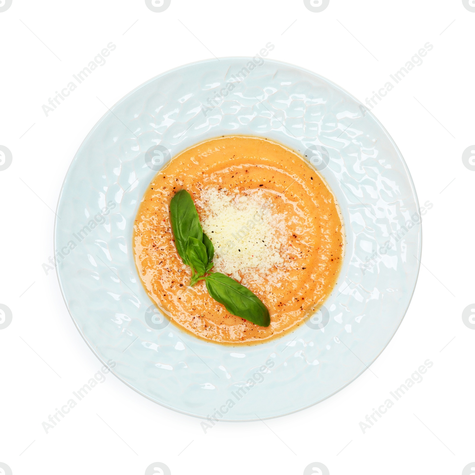 Photo of Delicious sweet potato soup with basil and parmesan cheese isolated on white, top view