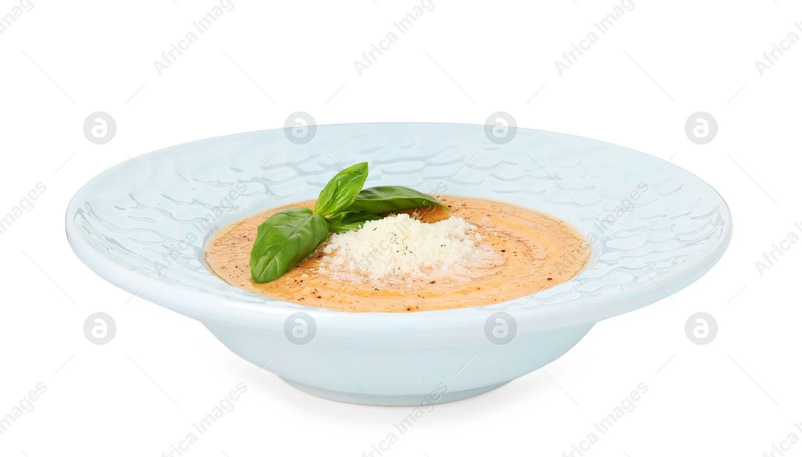 Photo of Delicious sweet potato soup with basil and parmesan cheese isolated on white