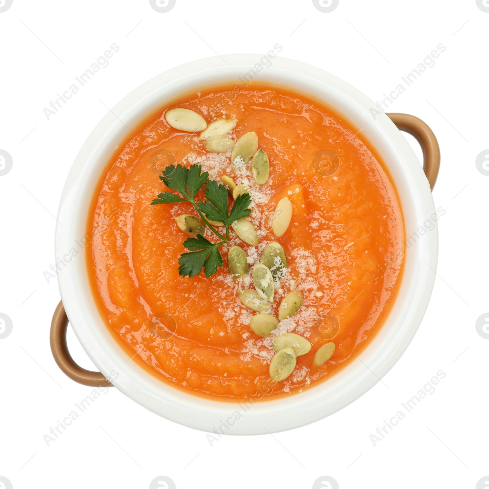 Photo of Delicious sweet potato soup with pumpkin seeds and parsley in bowl isolated on white, top view