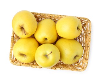 Photo of Many fresh yellow apples in wicker basket isolated on white, top view