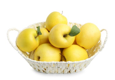 Photo of Many fresh yellow apples in wicker basket isolated on white