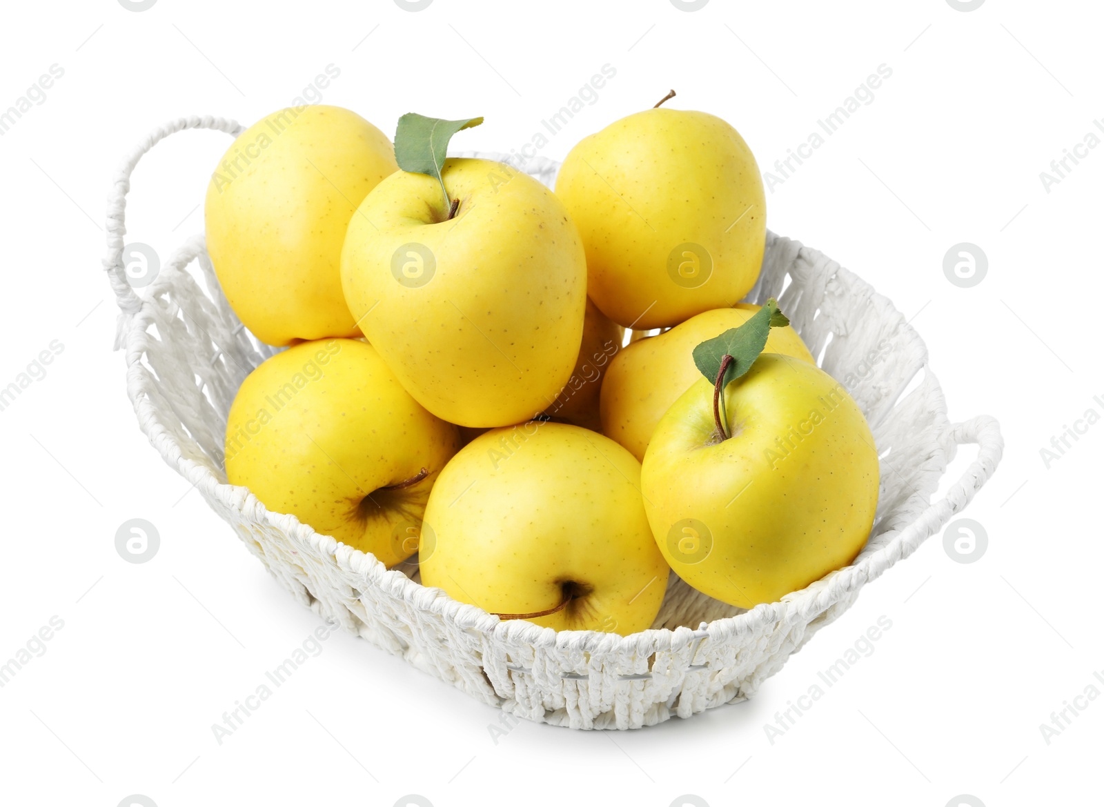 Photo of Many fresh yellow apples in wicker basket isolated on white