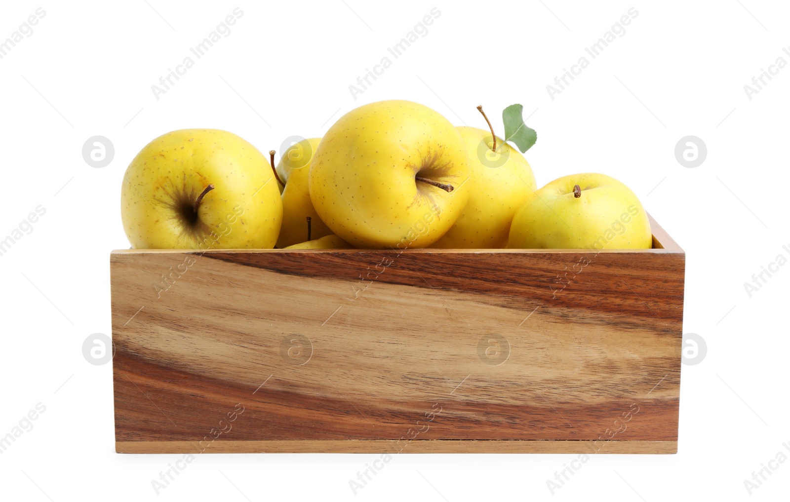 Photo of Ripe yellow apples in wooden crate isolated on white