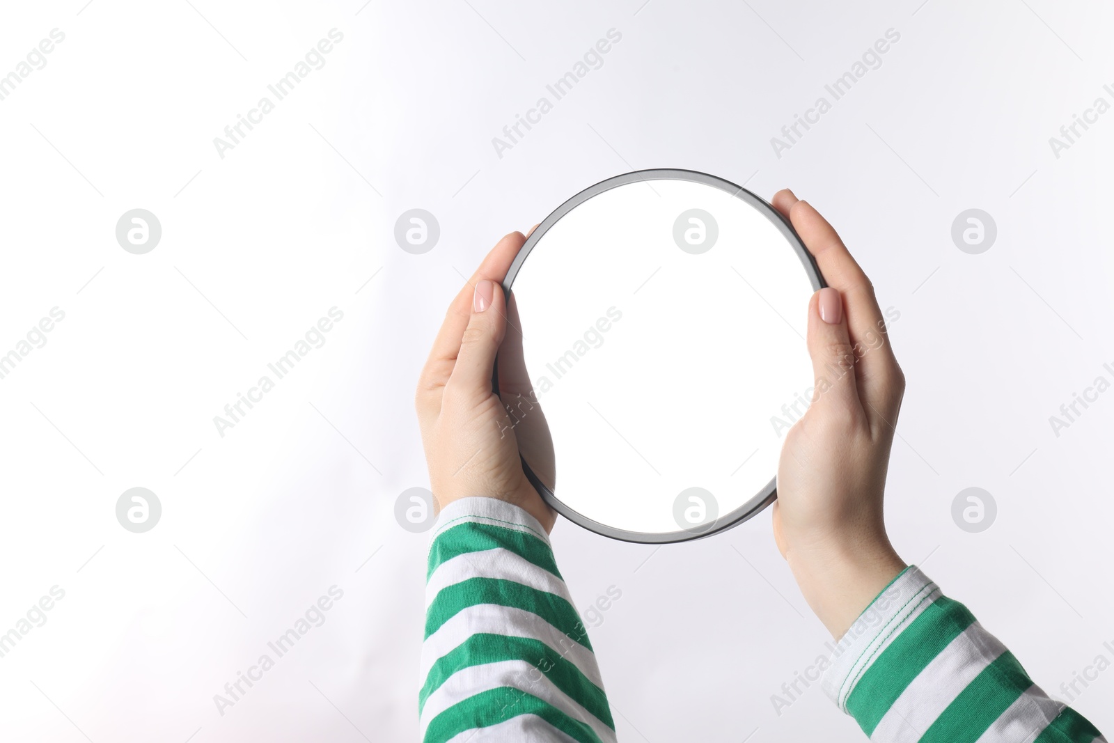 Photo of Woman holding round mirror on white background, closeup