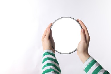 Woman holding round mirror on white background, closeup