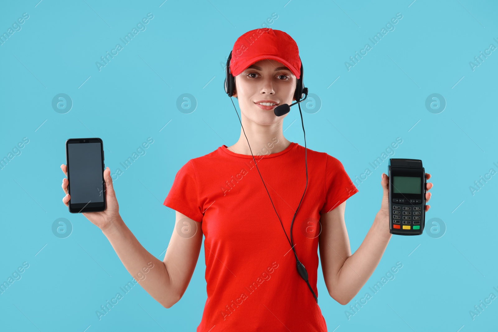 Photo of Fast-food worker smartphone and payment terminal on light blue background