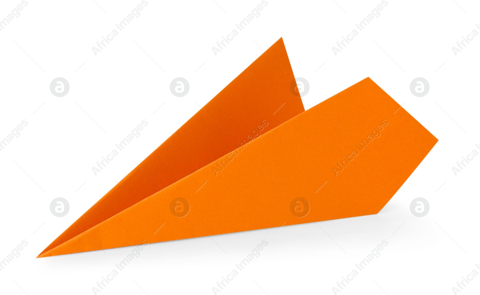 Photo of One handmade orange paper plane isolated on white