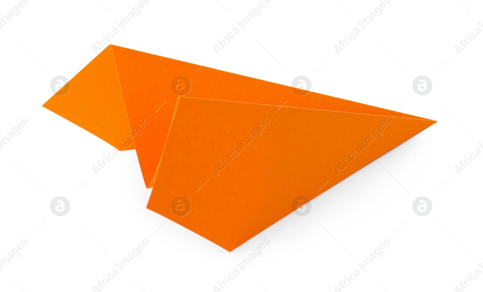 Photo of One handmade orange paper plane isolated on white