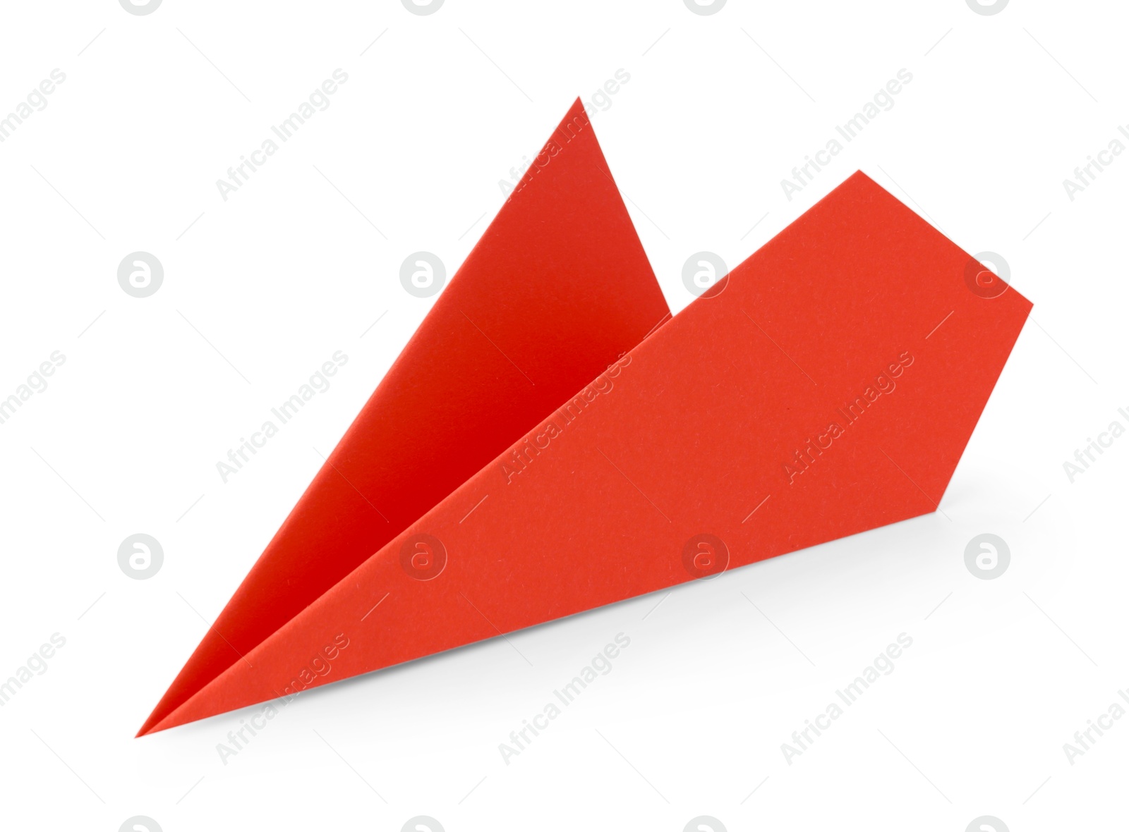 Photo of One handmade coral paper plane isolated on white