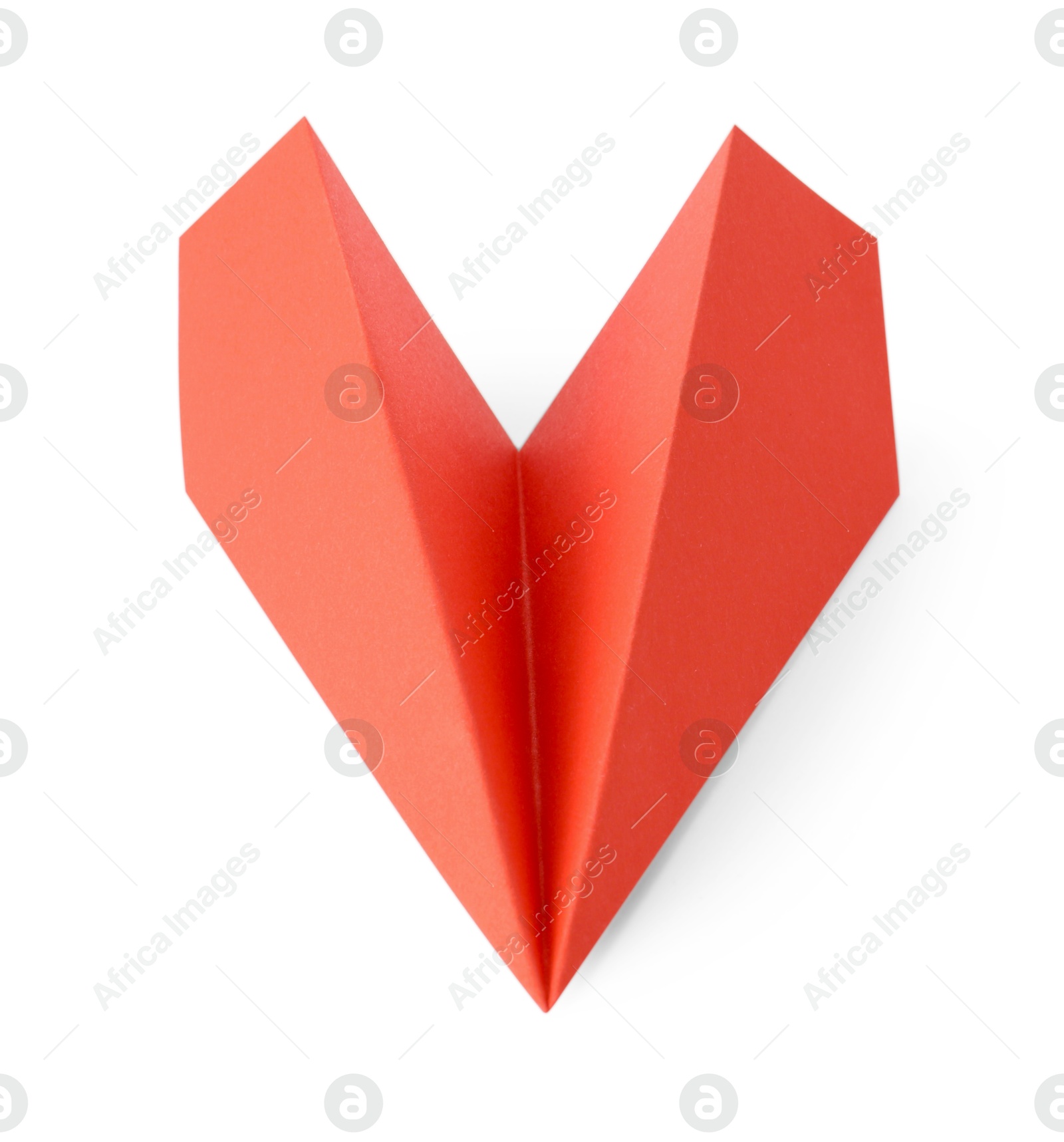 Photo of One handmade coral paper plane isolated on white