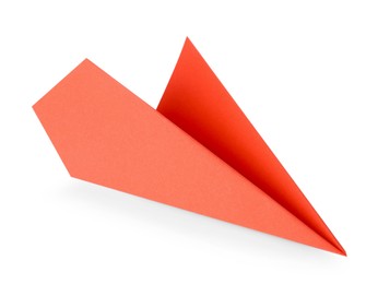 Photo of One handmade coral paper plane isolated on white