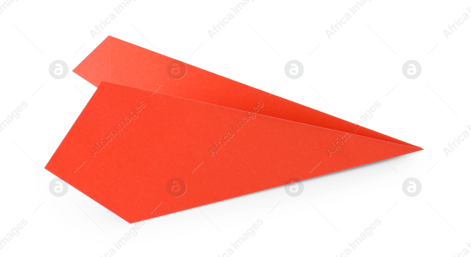 Photo of One handmade coral paper plane isolated on white