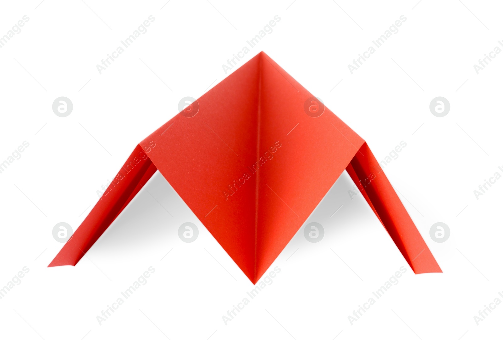 Photo of One handmade coral paper plane isolated on white