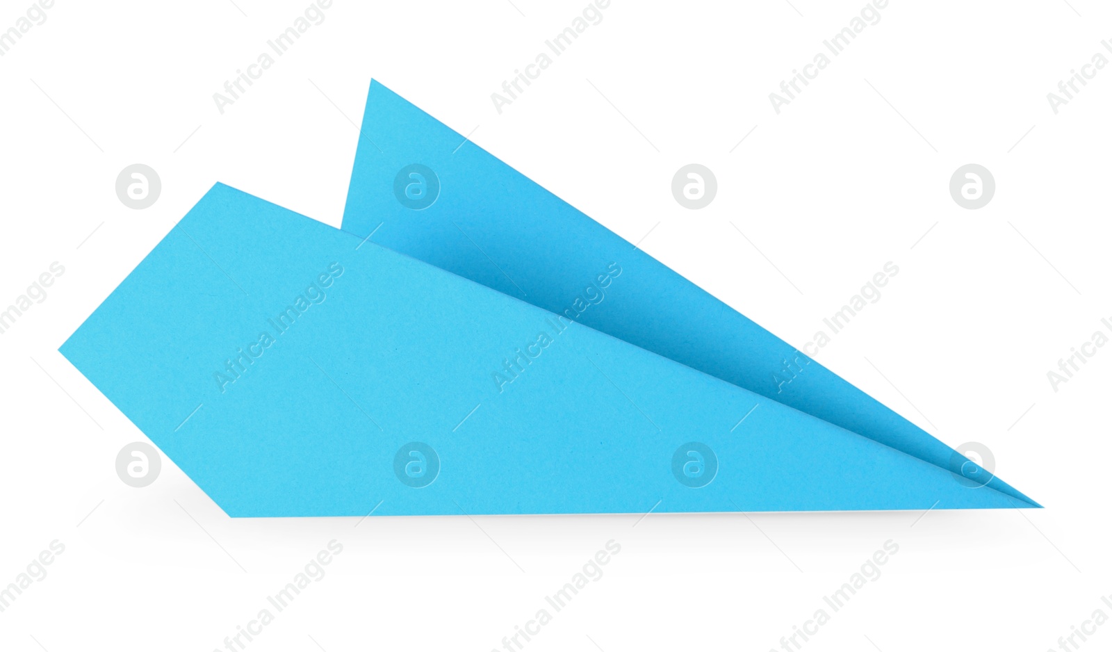 Photo of One handmade light blue paper plane isolated on white