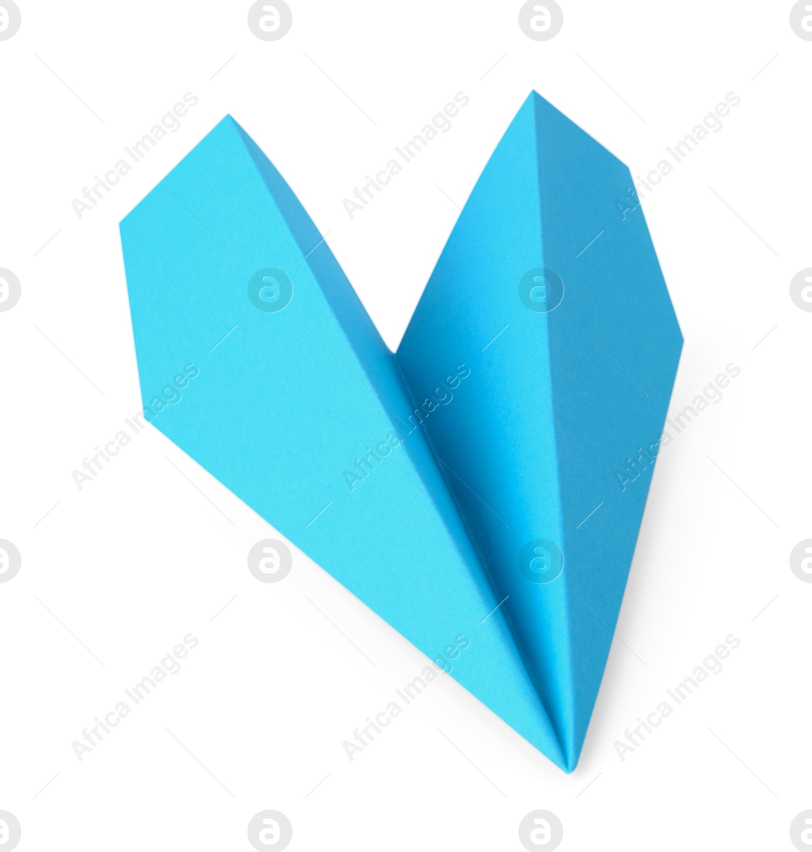 Photo of One handmade light blue paper plane isolated on white