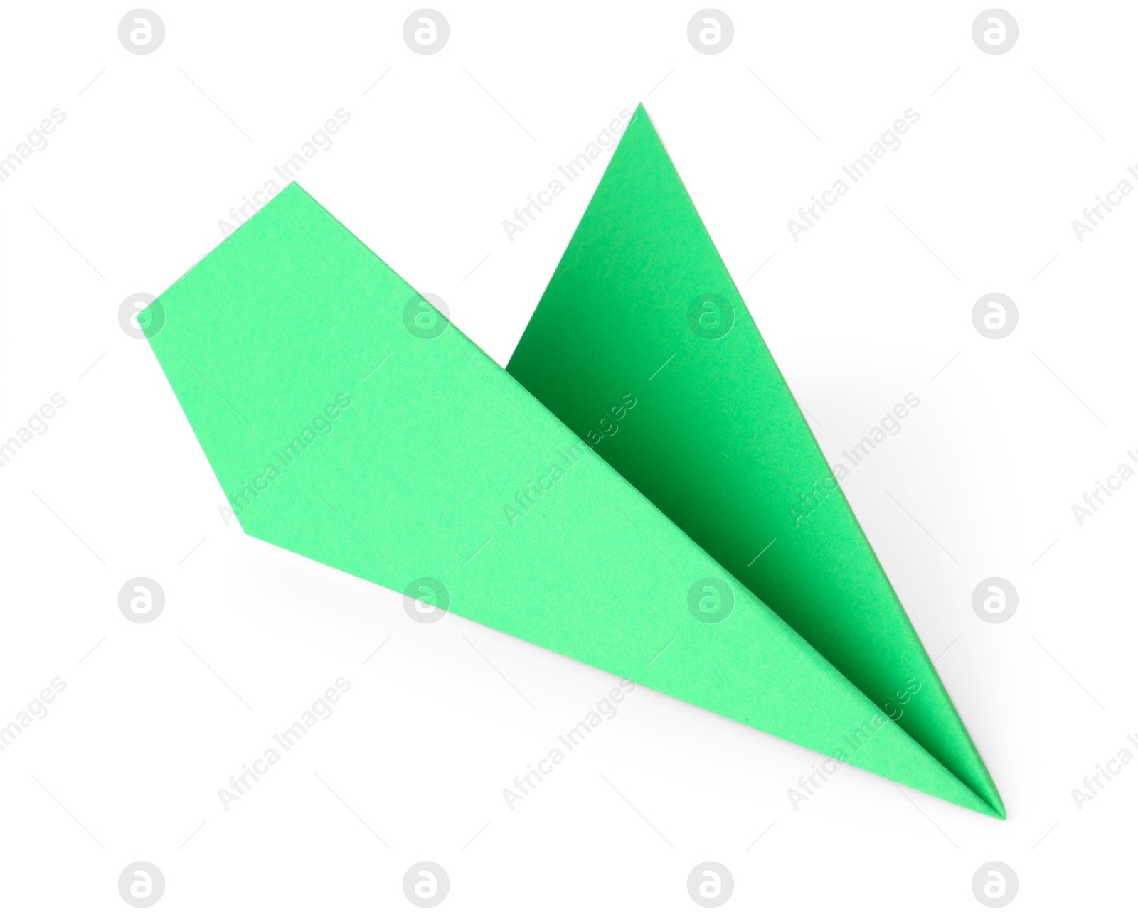 Photo of One handmade green paper plane isolated on white