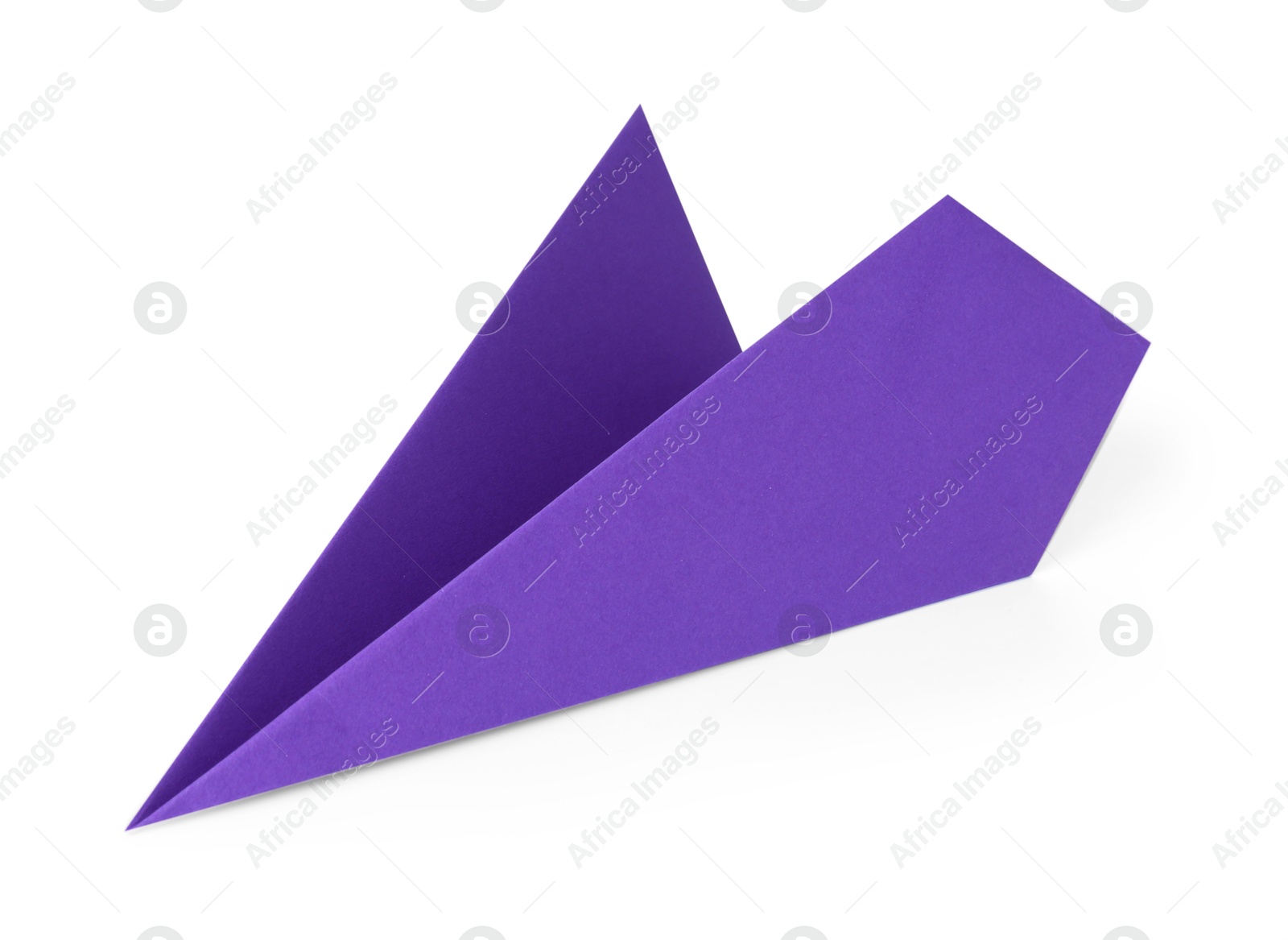 Photo of One handmade purple paper plane isolated on white