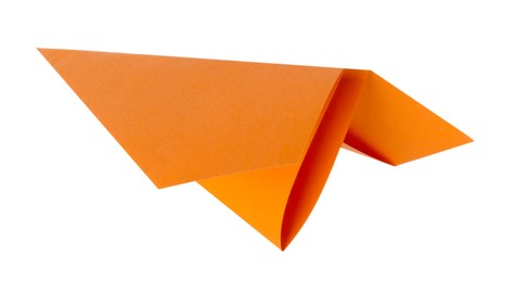 Photo of One handmade orange paper plane isolated on white